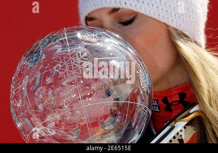 Lindsey Vonn from the U.S. kisses her trophy after winning the women's overall World Cup at the Alpine skiing World Cup finals in Schladming March 18, 2012. REUTERS/Leonhard Foeger (AUSTRIA - Tags: SPORT SKIING)