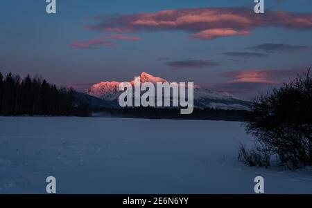 Coucher de soleil en soirée rouge vue de couleur sur le célèbre mont Krivan (2494m) vue d'hiver - symbole de la Slovaquie dans les montagnes des Hautes Tatras, Slovaquie. Banque D'Images