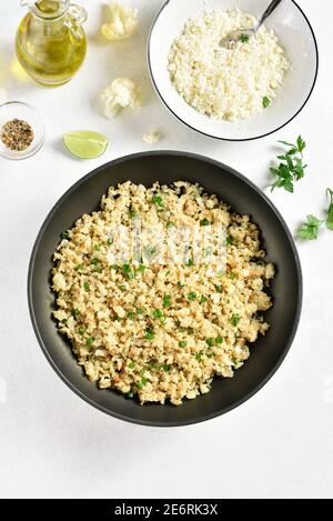 Riz au chou-fleur rôti sur fond de pierre légère. Vue de dessus, plan d'appartement Banque D'Images