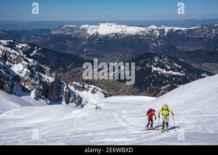 France, haute-Savoie, coombe du massif d'Aravis, ski de randonnée à Tete Pelouse, dans l'ascension du coombe de Bella Cha, vue sur la vallée des Confins Banque D'Images