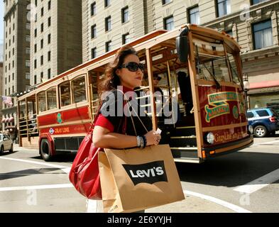 Vanessa Heshiki carries a shopping bag after a purchase at the Levi's  retail store in San Francisco, California April 13, 2010 when it announced  its first quarter earnings. Levi's has been opening company-owned stores  around the world as it offsets sales ...