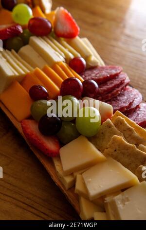 Carte de charcuterie italienne avec biscuits secs au fromage et salami planche en bois avec bord d'écorce brut Banque D'Images