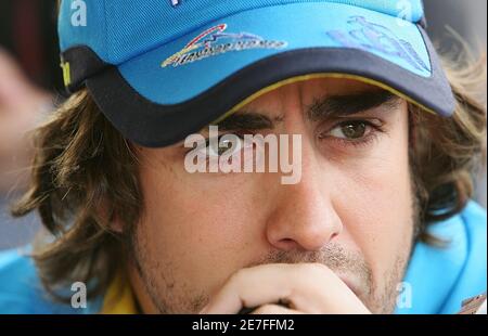 Spanish Formula One driver Fernando Alonso of Renault arrives in the paddocks for the upcoming Formula One World Championship Grand Prix of San Marino at the Enzo and Dino Ferrari racetrack in Imola, northern Italy, April 20, 2006. Alonso says the idea that Michael Schmacher could move to Renault next season is laughable. Speculation has swirled this week that Schumacher could switch from Ferrari to Renault when Alonso moves to McLaren next year. REUTERS/Daniele La Monaca