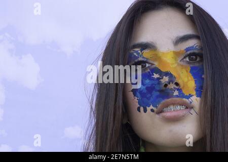 Drapeau de Bosnie-Herzégovine peint sur le visage d'un jeune femme Banque D'Images