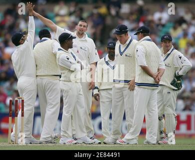 Steve Harmison of the World XI (4th left) is joined by team mates as he celebrates the wicket Matthew Hayden for 77 runs during day three of the Super Test in Sydney October 16, 2005. Australia are playing the World XI team in a one-off test match, after winning all three limited day matches in Melbourne last week. REUTERS/Will Burgess
