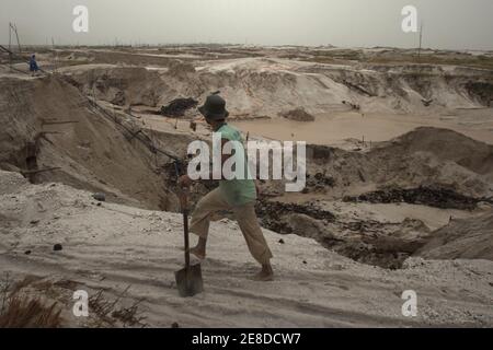 Une mine d'or qui marche sur le paysage sablonneux de la zone aurifère à petite échelle de Hampait, Katingan regency, province centrale de Kalimantan, Indonésie. Banque D'Images