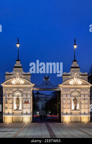 Entrée principale historique de l'Université de Varsovie la nuit, vue de la rue Krakowskie Przedmiescie dans la ville de Varsovie, Pologne, architecture baroque de renouveau. Banque D'Images