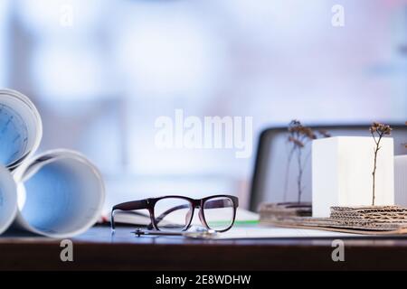 mise au point sélective de lunettes à proximité de plans roulés sur le bureau bureau Banque D'Images