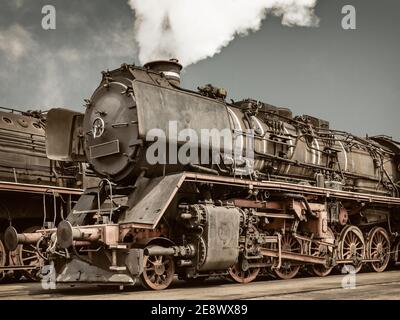 Vue latérale de style rétro d'une ancienne locomotive à vapeur rouillée Banque D'Images