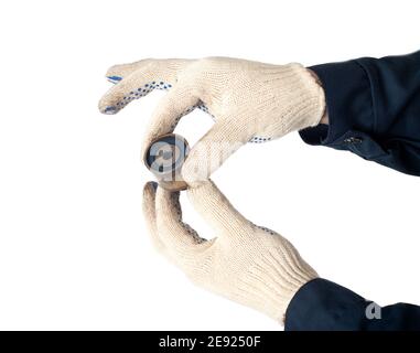 Un mécanicien de bord maintient et vérifie le tendeur de courroie de distribution sur un fond blanc, isoler. Rouleau de distribution défectueux Banque D'Images