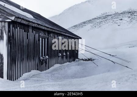 Photo en niveaux de gris d'une ancienne grange en bois dans une neige paysage d'hiver Banque D'Images