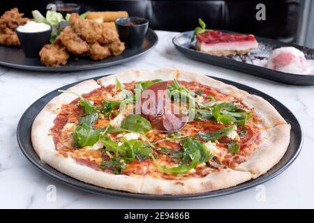 Sheffield, Royaume-Uni - 03 août 2017 : pizza au salami pepperoni et à la roquette, SFC et cheesecake à OHM, Fitzwilliam Street Banque D'Images