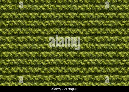 Tissu tricots vert texture. Instantané de macro de texture de couture machine. Arrière-plan tricoté. Banque D'Images