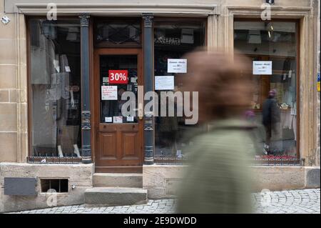 04 février 2021, Bade-Wurtemberg, Tübingen: Une femme passe devant une entreprise fermée dans le éclusage de Corona. (À dpa 'Corona-Lockdown: L'opposition veut voir 'la lumière à la fin du tunnel') photo: Sebastian Gollnow/dpa Banque D'Images