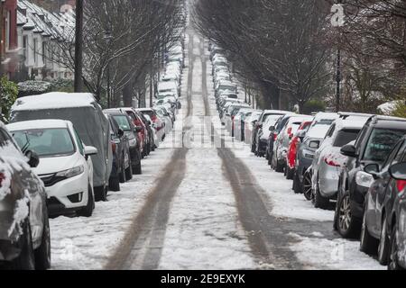 Longue rangée de voitures garées couvertes de neige sur Londres rue autour du quartier de Crouch End comme la capitale London expériences une couverture rare de neige Banque D'Images