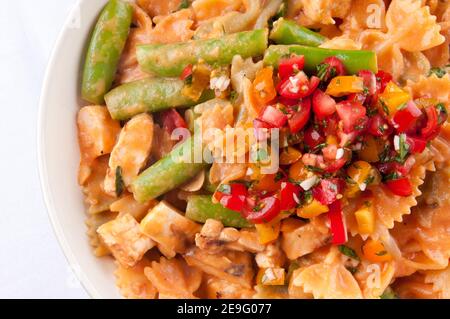 les pâtes bowtie au poulet et aux tomates fraîches dans une sauce crémeuse mais à la hea Banque D'Images