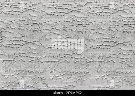Texture de béton - un gros plan d'un fragment d'un paroi grise non uniformément plâtrée Banque D'Images