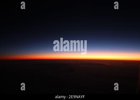 Lever du soleil au-dessus de l'horizon à 35 000 pieds au-dessus de l'Australie centrale Banque D'Images