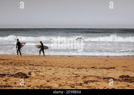 Deux surfeurs ont une vue sur les vagues de l'océan Austral à Moyji ou point Ritchie à Warrnambool, dans le sud-ouest de Victoria, en Australie Banque D'Images