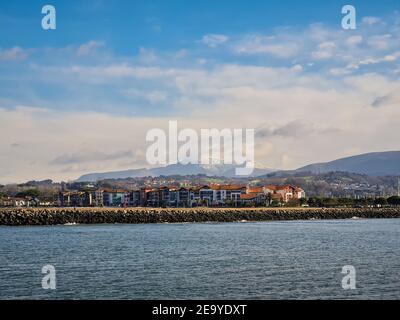 Hendaye village traditionnel français au bord de la mer Cantabrique, le mont la Rhune Larrun recouvert de neige en hiver. Paysage de Hondarribi Banque D'Images