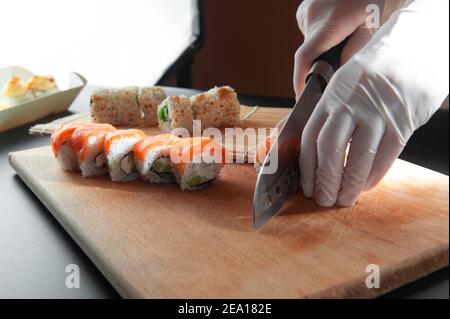 des cuisiniers masculins préparent des sushis dans la cuisine du restaurant. Banque D'Images