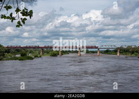 Grand angle de la rivière Sabie qui coule fortement avec le Shalati train Lodge au-dessus de lui sur le pont Selati Banque D'Images