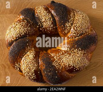 Un pain slave doux, fait en forme d'anneau, appelé Kalach, sur une planche en bois Banque D'Images