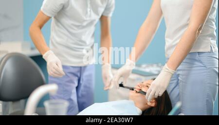 Dentiste photographiant le résultat de son travail Banque D'Images