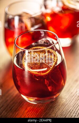 Cocktail classique Negroni et boisson courte au gin avec vermouth doux, liqueur rouge amère et garniture d'orange séchée. Banque D'Images
