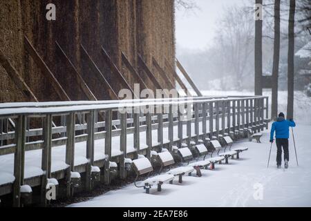 Bad Oeynhausen, Allemagne. 08 février 2021. Un homme court le long de la maison de remise des diplômes sur des skis de fond. Après le début de l'hiver, le grand froid arrive en Rhénanie-du-Nord-Westphalie. Selon les prévisions du service météorologique allemand à partir de lundi, les températures ne s'élèveront pas au-dessus de zéro degré même pendant la journée jusqu'au week-end (13./14.02.2021). Crédit : Lino Mirgeler/dpa/Alay Live News Banque D'Images