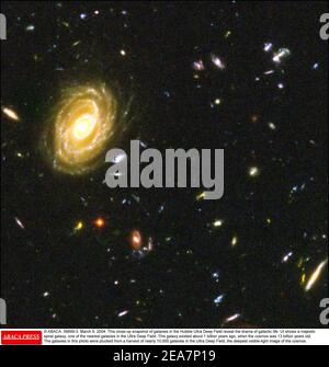 © ABACA. 56999-3. 9 mars 2004. Ce gros plan des galaxies du Hubble Ultra Deep Field révèle le drame de la vie galactique. UT montre une majestueuse galaxie spirale, l'une des galaxies les plus proches dans le champ ultra profond. Cette galaxie existait il y a environ 1 milliard d'années, alors que le cosmos avait 13 milliards d'années. Les galaxies de cette photo ont été cuelies d'une récolte de près de 10,000 galaxies dans le champ ultra profond, l'image la plus profonde de la lumière visible du cosmos. Banque D'Images