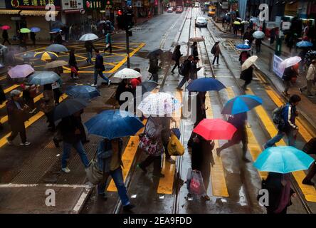 Hong Kong. Hennessy Road. Jour de pluie. Les piétons se précipitent de l'autre côté de la route. Banque D'Images