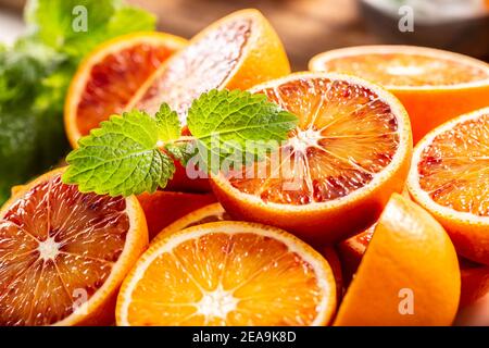 Des oranges siciliennes de sang coupées avec de la melissa fraîche - gros plan Banque D'Images