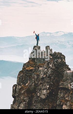 Homme debout au sommet d'une falaise de montagne voyage aventure escalade en plein air Voyage de vacances extrêmement actif randonnée en Norvège pic Husfjellet Banque D'Images