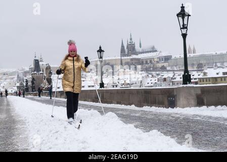 Une femme ski de fond sur le célèbre pont Charles. De fortes chutes de neige ont perturbé le chemin de fer, la route et les transports en commun dans toute la République tchèque. Banque D'Images