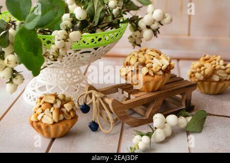 Muffins aux arachides faits maison avec baies blanches sur la décoration sur la merde arrière-plan en bois Banque D'Images