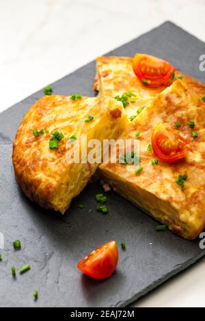 Tortilla espagnole avec tomates et ciboulette Banque D'Images