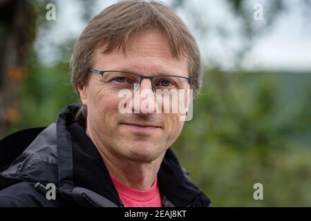 Portrait d'un homme avec des lunettes et paysage de bokeh Banque D'Images