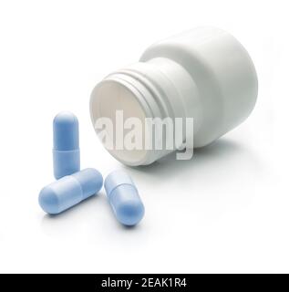 Pilules de couleur bleue et pot blanc Banque D'Images