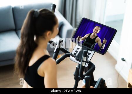 Entraînement de femme sur l'entraîneur elliptique en ligne Banque D'Images