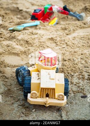 Jouet et camion de bulldozer au terrain de jeu sablonneux Banque D'Images