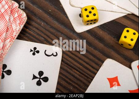 Jouer aux cartes et aux dés sur une table en bois. Gros plan, mise au point sélective. Banque D'Images