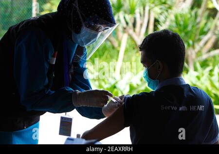 Bogor, Indonésie. 11 février 2021. Une travailleuse de la santé vaccine sa collègue lors d'une vaccination de masse des travailleurs de la santé et des travailleurs de la santé âgés à Bogor, dans l'ouest de Java, le 11 février 2021. (Photo par Adrian/INA photo Agency/Sipa USA) crédit: SIPA USA/Alay Live News Banque D'Images