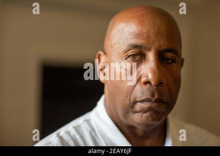 Homme afro-américain senior qui ne sourit pas et qui a l'air déprimé. Banque D'Images