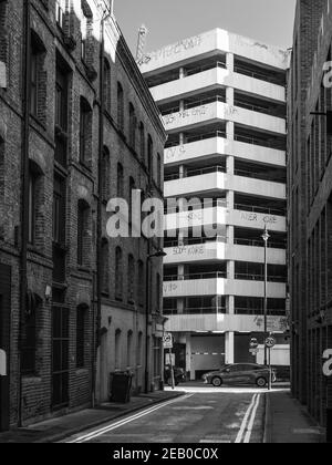 Vue de l'arrière-rue sur Christina Street à Shoreditch, Londres vers l'arrière du lavage de voiture américain et le parking de plusieurs étages Banque D'Images