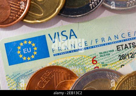 Visa Schengen dans le passeport avec quelques pièces. Émis par l'Ambassade de France. Cet échantillon du visa Schengen est mis en circulation depuis 201 Banque D'Images