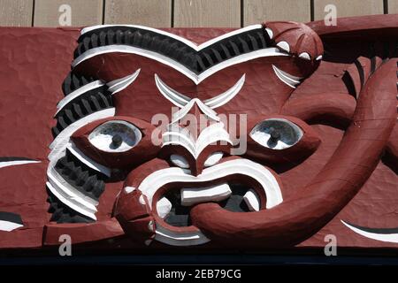 Maori carving - face carved in the wood. Rotorua, New Zealand. Stock Photo