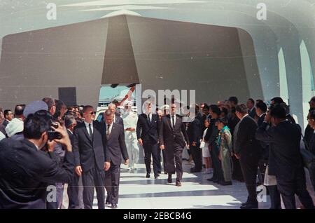 Voyage dans les États de l'Ouest : Honolulu, Hawaï, visite du Mémorial de l'USS Arizona, 14:40. Le président John F. Kennedy (au centre) traverse le USS Arizona Memorial lors d'une visite à Pearl Harbor à Honolulu, Hawaï. Marchant en groupe avec le président Kennedy (de gauche à droite) : non identifié (portant des lunettes de soleil); agent du Service secret de la Maison Blanche, Don Lawton; gouverneur d'Hawaii, John A. Burns; aide navale au président, capitaine Tazewell T. Shepard, Jr. (À l'arrière); commandant en chef de la flotte du Pacifique (CINCPACFLT), amiral John H. Sides; Le Président; le sénateur Daniel Inouye (Hawaii); commandant en chef Banque D'Images