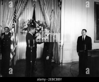 Remise de la Médaille du service distingué (DSM) au général Lauris Norstad, 12:45. Le président John F. Kennedy remet la Médaille du service distingué au général Lauris Norstad, commandant suprême allié à la retraite de l'OTAN; le président Kennedy (au centre à gauche) remet la médaille au général Norstadu0027s lapel. L'aide navale au président, le capitaine Tazewell T. Shepard, Jr., se trouve à gauche, en arrière-plan; le secrétaire à la Défense, Robert S. McNamara (debout derrière le pupitre), observe à droite. East Room, White House, Washington, D.C. Banque D'Images