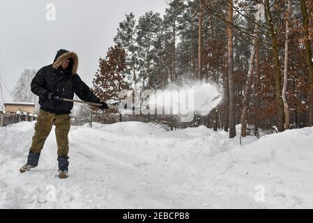 Non exclusif: HAVRYLIVKA, UKRAINE - 12 FÉVRIER 2021 - UN homme pique la neige à l'extérieur d'une maison dans le village de Havrylivka, région de Kiev, dans le nord de l'Ukraine. Banque D'Images